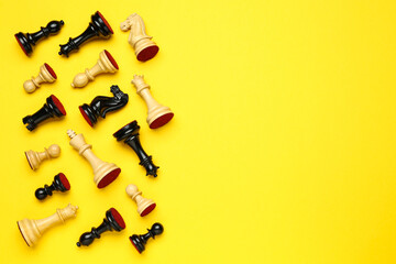 Many different chess pieces on yellow background, flat lay. Space for text
