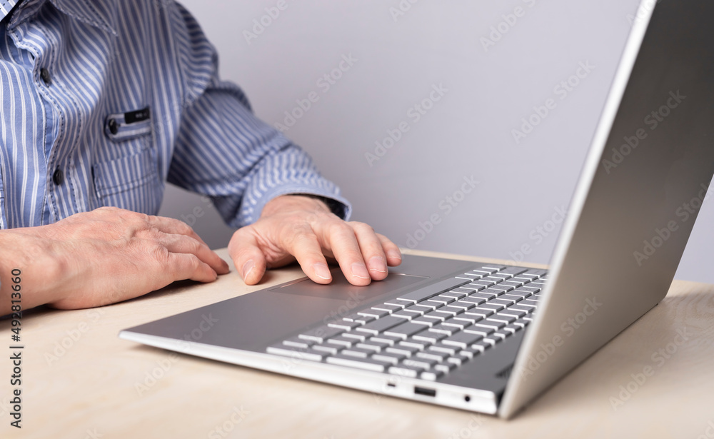 Aufkleber man hand closeup on laptop touchpad. using computer for information search, distant work and educati