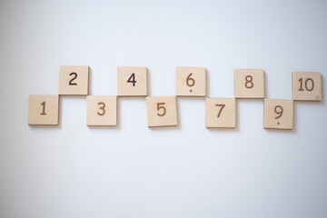 Wooden bricks with numbers on very white background. Educational toys. Top view image with space for text.