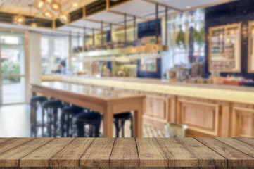 Wooden board empty table blurred restaurant background used for display products