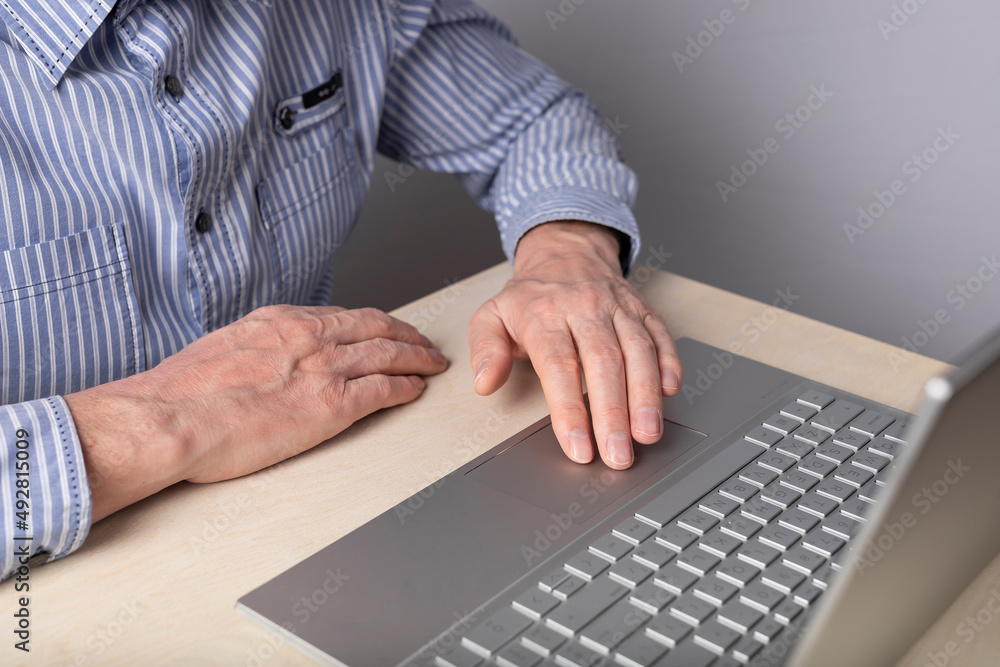 Poster man hand closeup on laptop touchpad. using computer for entertainment, freelance work and distant ed
