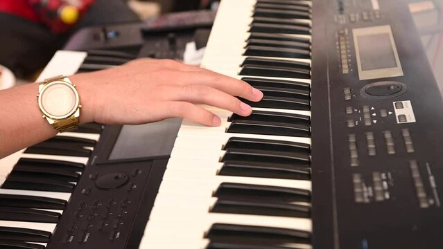 a man's hand playing electone or keyboard