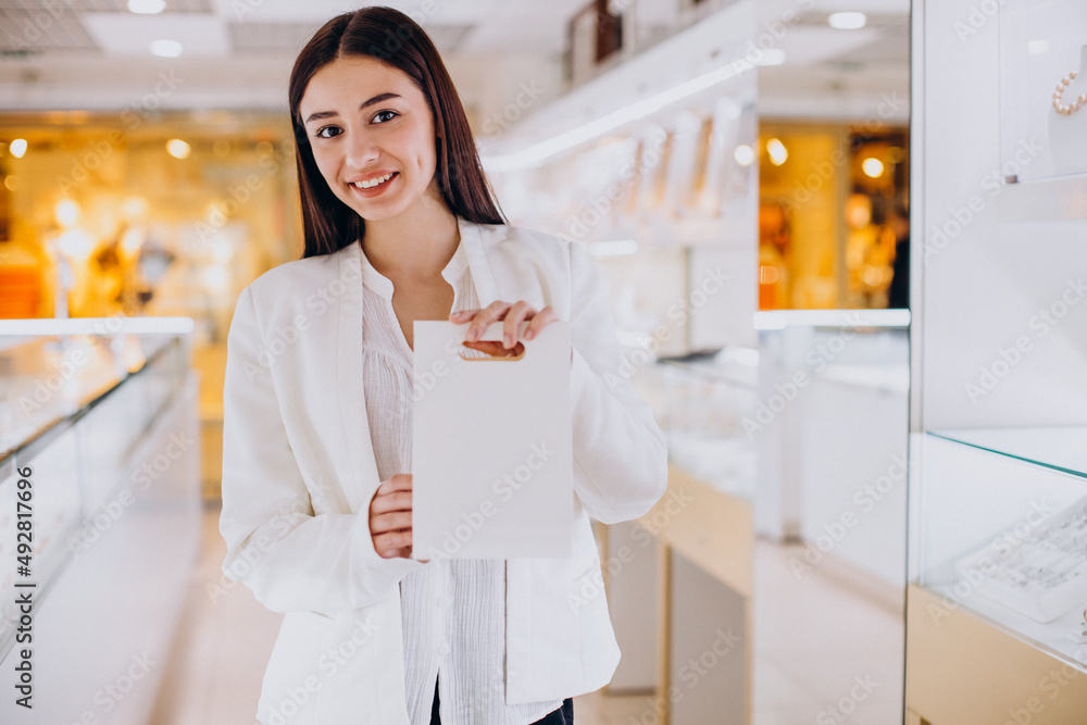 Wall mural Female sales person at jewelry store