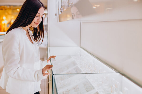 Woman Choosing Jewelry At Jewelry Store