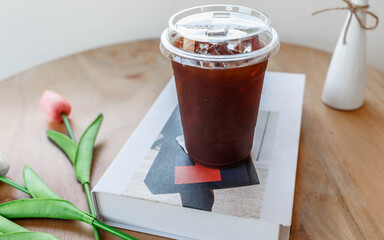 plastic cup iced Americano Coffee on the table in the coffee shop