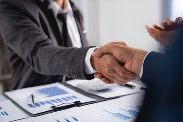 Business people shaking hands, finishing up meeting,  business handshake for successful of investment deal, teamwork and partnership concept.