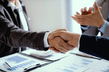 Business people shaking hands, finishing up meeting,  business handshake for successful of investment deal, teamwork and partnership concept.