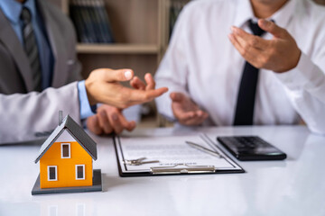 Fototapeta premium Real estate agent talked about the terms of the home purchase agreement and asked the customer to sign the documents to make the contract legally, Home sales and home insurance concept.