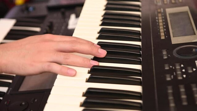 a man's hand playing electone or keyboard