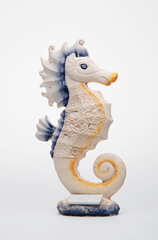 Gypsum figurine of a seahorse on a white background © Alexander