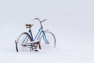 Old bicycle and snow during Winter