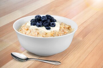 Tasty breakfast Oatmeal porridge in white bowl