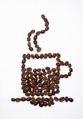 Silhouette of coffee cup  made with coffee beans and coffee grains on white background