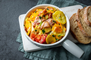 Casserole of potatoes, sweet potatoes, zucchini, tomatoes, onions and bacon