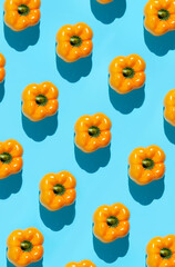 Abstract top view background of fresh yellow vegetables pattern on vibrant blue background, healthy eating and vegan concept