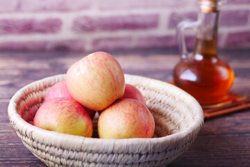 apple vinegar in glass bottle with fresh green apple on table 