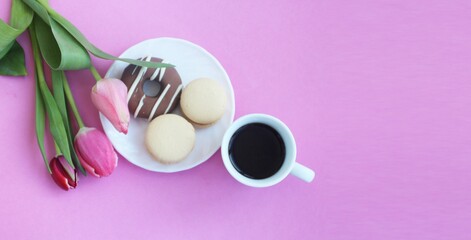 Festive spring breakfast - pink tulips, espresso coffee, cakes. Background for a greeting card.