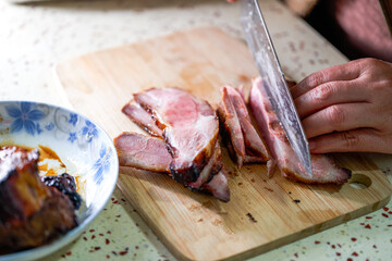 A chef is making fillings for char siu bao, dicing char siu pork