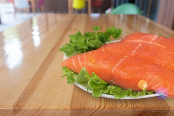 Fresh fish fillet. On a wooden background.