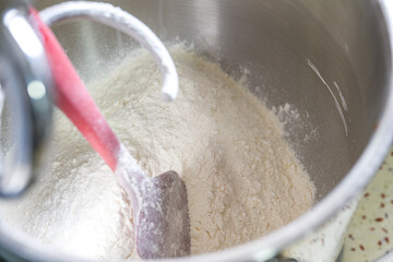 A kitchen machine is mixing dough