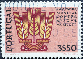 Portugal - circa 1963: a postage stamp from Portugal, showing a Wheat Emblem. FAO Freedom from...