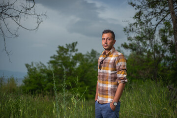 man in shirt with strips pictured in nature