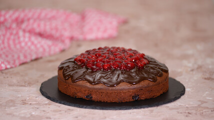 Traditional homemade chocolate cake sweet pastry dessert with brown icing, cherries.