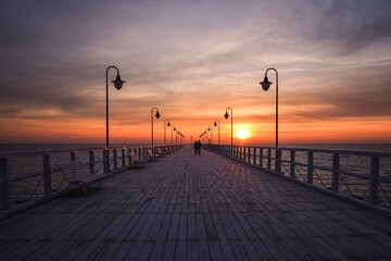 Fototapeta na wymiar Beautiful morning seaside landscape. Wooden pier with a colorful sky in Gdynia, Poland.