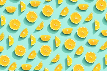 Lemon fruit as bring summer food pattern, slices of yellow citrus with hard shadows at sunlight on pastel mint background. Healthy fruits food concept. Flat lay with bright juicy lemon