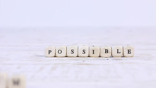 Wooden blocks with Impossible sign going to Possible. Concept of Opportunity, Motivation and Success. High quality 4k video.
