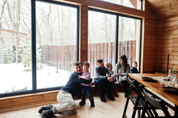 Large family in modern wooden house spending time together in warm and love.