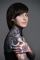 Be an original, everyone else is already taken. A cropped studio portrait of a tattooed young woman.