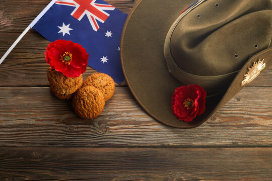Australian Anzac Day. Australian army slouch hat and traditional Anzac biscuits on wooden background.