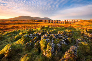 Beautiful scenic view with golden morning light at Ribblehead Viaduct in The Yorkshire Dales National Park, UK. - obrazy, fototapety, plakaty