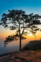 Beautiful view of the sunset on the mountains in the tropical forest of Thailand.