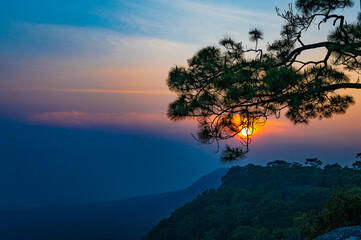 Beautiful view of the sunset on the mountains in the tropical forest of Thailand.