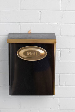 Steel mailbox mounted on a stone wall