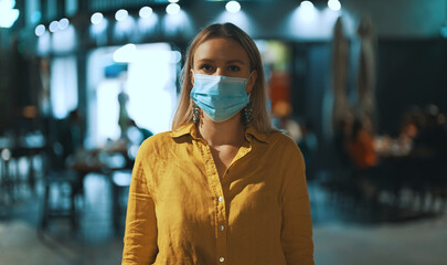 Woman in medical mask on the street. Wear mask in public place.