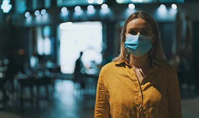 Woman in medical mask on the street. Wear mask in public place.