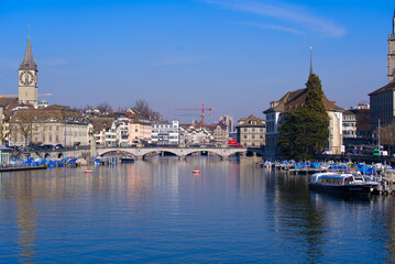 Fototapeta na wymiar Skyline of the medieval old town of Zürich with river Limmat in the foreground on a sunny spring day. Photo taken March 3rd, 2022, Zurich, Switzerland.