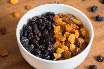 Round white bowl with grape on the table