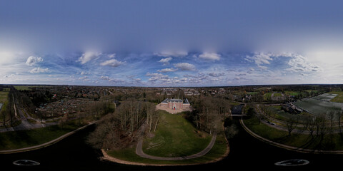 Ready for VR 360 degrees aerial panorama of Slot Zeist castle with the moated manor surrounded by green park and urban landscape in the background. Dutch stately venue seen from above.
