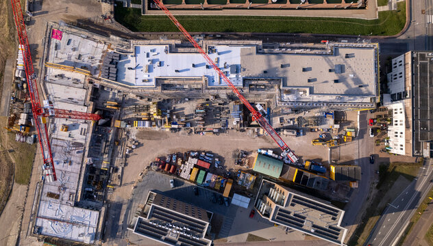 Top down view on luxury apartment comples construction site Kade Zuid part of the new Noorderhaven neighbourhood at river IJssel. Aerial industrial view of building plot. Housing and urban management.