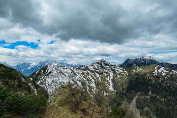 Fototapeta na wymiar Panoramic view on Frauenkogel (Dovska Baba) with mountain peaks in the Karawanks, Carinthia, Austria. Borders Austria, Slovenia, Italy. Triglav National Park. Mount Triglav and Mangart in the back