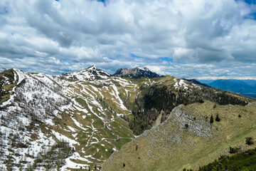 Panoramic view on Frauenkogel (Dovska Baba) with mountain peaks in the Karawanks, Carinthia, Austria. Borders Austria, Slovenia, Italy. Triglav National Park. Mount Triglav and Mangart in the back