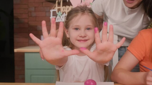 Mom and daughter are getting ready to celebrate Easter and paint eggs. Kiss your daughter.