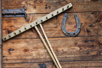 old horseshoe and rake on a wooden door