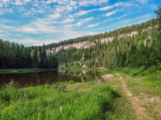 The picturesque bank of the Usva River with a view of the Usvinskiye Pillars rock massif. Perm region. Russia
