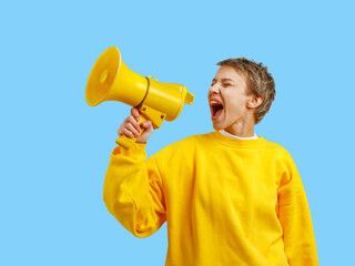 a girl in yellow clothes screams for help into a megaphone. blue background. colors of the national flag of Ukraine