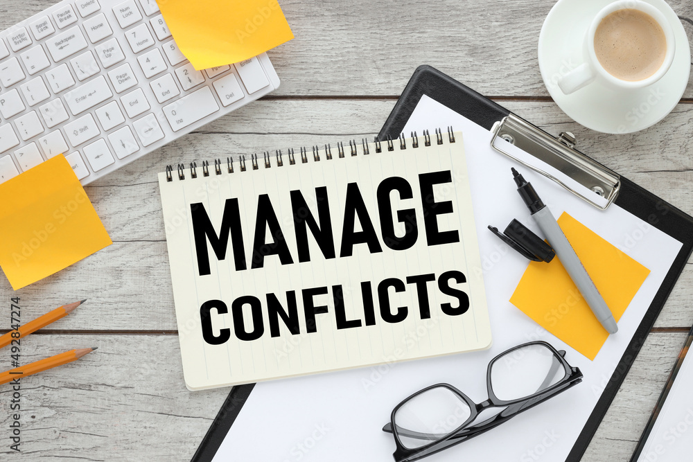 Poster manage conflicts text on notebook near computer keyboard and yellow stickers